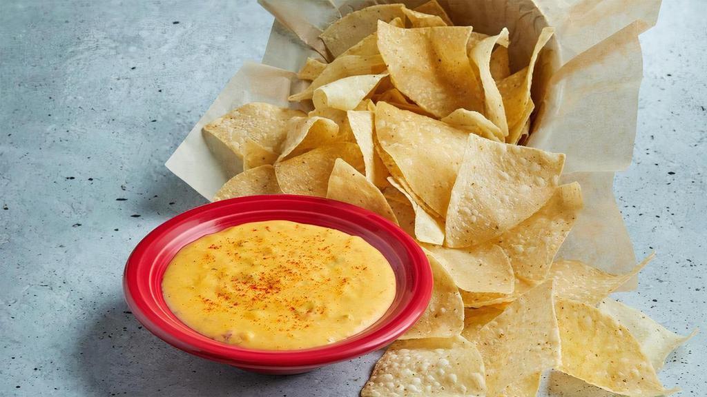 Queso · Melted cheese in our signature salsa.