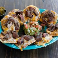 Steak Nacho · Mesquite grilled fajita steak atop refried beans & mixed cheese melted to perfection. Served...