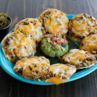 Ground Beef Nacho · Seasoned ground beef atop refried beans & mixed cheese melted to perfection. Served with a s...