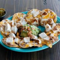 Chicken Nacho · Mesquite grilled fajita chicken atop refried beans & mixed cheese melted to perfection. Serv...