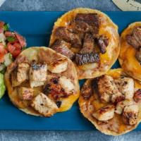 Combo Nacho · Mesquite grilled fajita chicken and steak atop refried beans & mixed cheese melted to perfec...