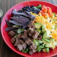 Steak Fajita Salad · Fajita steak, mixed greens, shredded cheese, cherry tomatoes, roasted corn, black beans, tor...