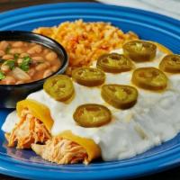 Sour Cream Enchiladas · Two pulled chicken enchiladas rolled in corn tortillas, smothered in sour cream sauce & topp...