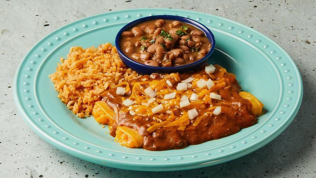 Classic Cheese Enchiladas · Two traditional enchiladas rolled in a corn tortilla, covered in your choice of chili con carne or queso topped with onions.