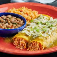 Verde Enchiladas · Two pulled chicken enchiladas rolled in a corn tortilla, smothered with verde sauce & topped...