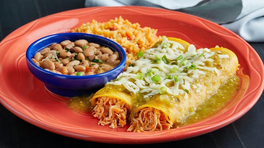 Verde Enchiladas · Two pulled chicken enchiladas rolled in a corn tortilla, smothered with verde sauce & topped with jack cheese & green onions.