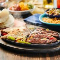 1/2 Pound Combo Fajitas · Mesquite grilled fajitas sizzling atop grilled onions & bell peppers. Served with guacamole,...