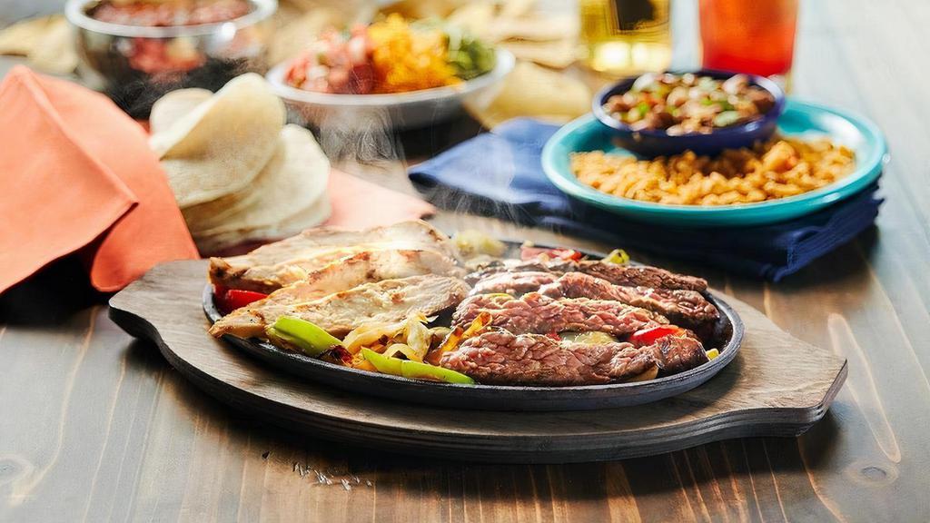 Full Pound Combo Fajitas · Mesquite grilled fajitas sizzling atop grilled onions & bell peppers. Served with guacamole, pico de gallo, cheese, Spanish rice & charro beans. Serves 3-4 people.