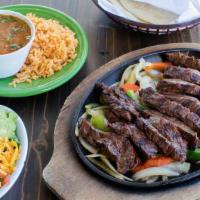 Full Pound Steak Fajitas · Mesquite grilled fajitas sizzling atop grilled onions & bell peppers. Served with guacamole,...
