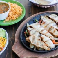 Full Pound Chicken Fajitas · Mesquite grilled fajitas sizzling atop grilled onions & bell peppers. Served with guacamole,...