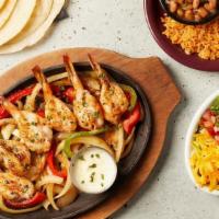 Grilled Shrimp Fajitas · Six mesquites grilled jumbo shrimp served atop a sizzling skillet with a side of frothy garl...