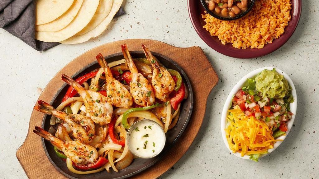 Grilled Shrimp Fajitas · Six mesquites grilled jumbo shrimp served atop a sizzling skillet with a side of frothy garlic butter..
