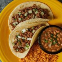 Slow-Roasted Brisket Tacos · Two slow-roasted brisket tacos, served in our pillow-soft tortillas, topped with fresh cilan...