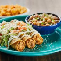 Tacos Dorados · Three fried corn tortillas stuffed with pulled chicken. Topped with salsa verde, chopped let...