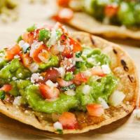 Avocado Toast-Adas · Vegetarian. Two crispy round corn tortillas topped with our made from scratch guacamole, pic...