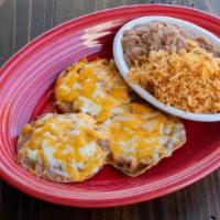 Kid Nacho · Refried beans & cheese melted on tortilla chips. served w/ rice & refried beans.
