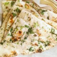 Garlic Naan · Plain flat white bread baked in a clay oven sprinkled with garlic and cilantro.