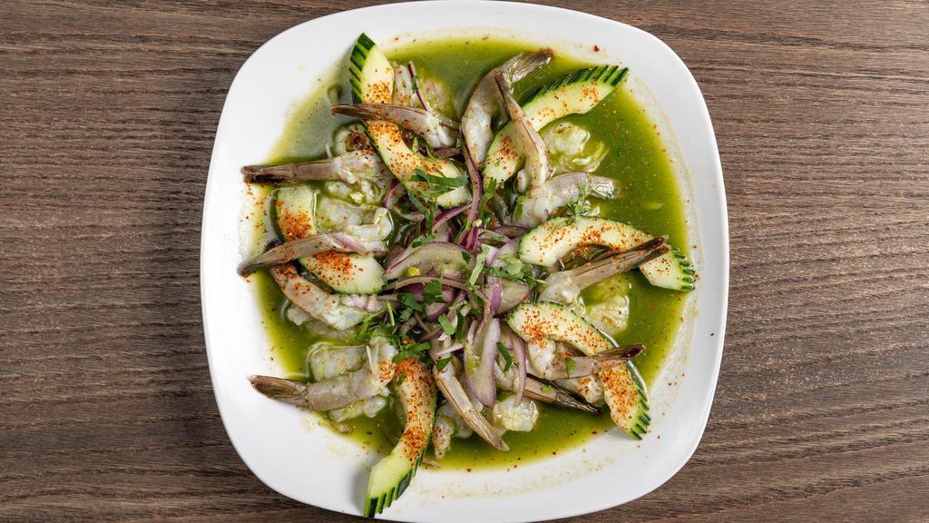 Aguachile Mazatlan · Raw shrimp marinated in fresh lime jalapeño sauce. Served with sliced red onions and cucumber