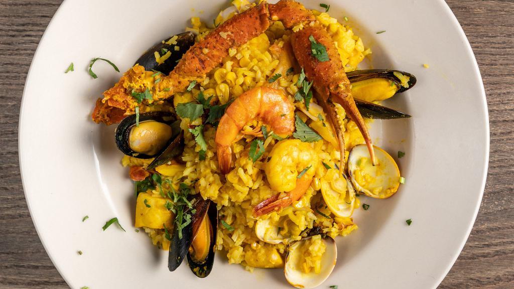 Seafood Paella · A colorful rice dish bursting with shrimp octopus, fish, mussels, crab legs and saffron for tons of flavor