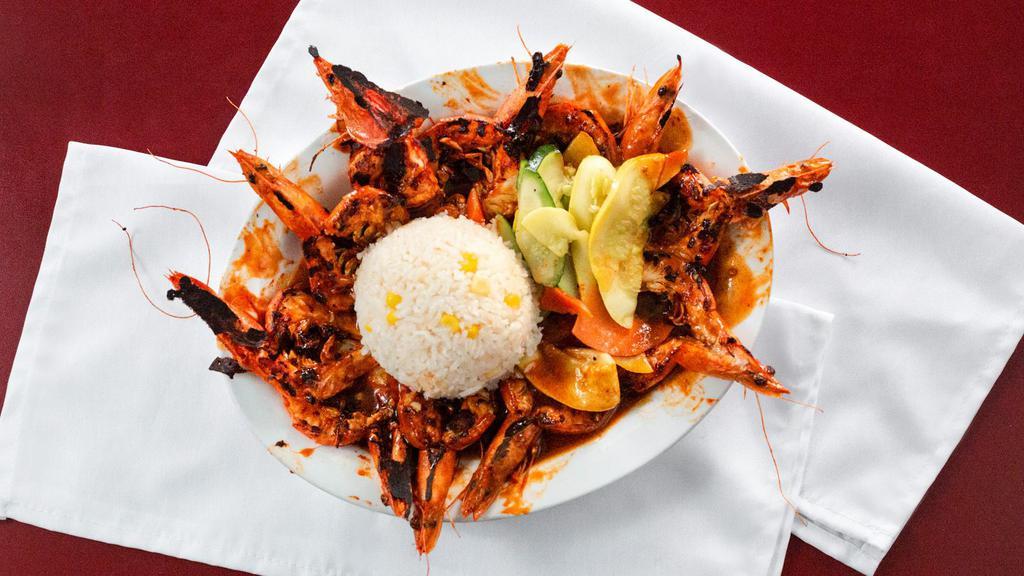Camarones Zarandeados / Shaken Shrimp · Butterfly cut head on shrimp marinated in huichol sauce and citrus juice served with a side of rice and vegetables