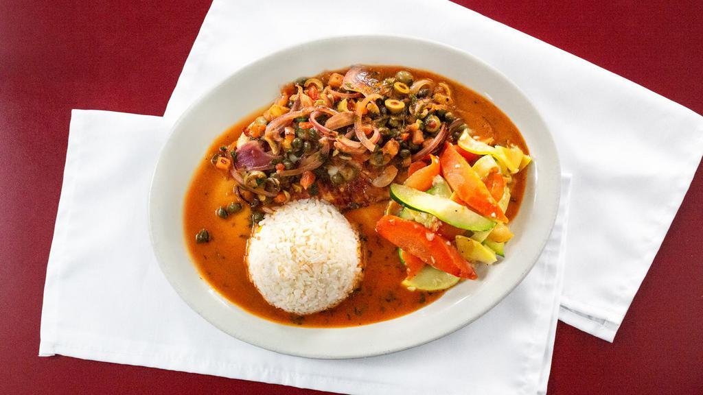 Filete A La Veracruzana · Pan seared fish fillet topped with tomato, onions, bell peppers, olives, capers, served with rice and vegetables.
