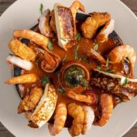 Molcajete Chamuco · Combination of bacon wrapped shrimps, fried shrimps, grilled shrimp, shell on shrimps
and pa...