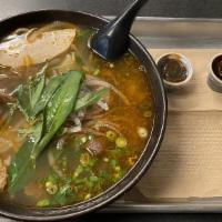 Spicy Beef Noodle Soup · Lemongrass flavored beef broth served thick noodles and choice of meats.  Garnished with gre...