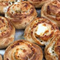 Cheesy Garlic Knots · Four garlic knots served with marinara