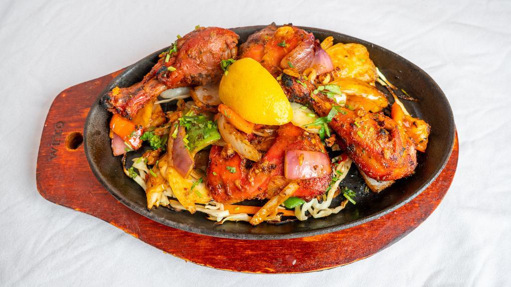 Chicken Tandoori · Chicken leg quarters marinated in yogurt and spices and barbecued in tandoor oven.