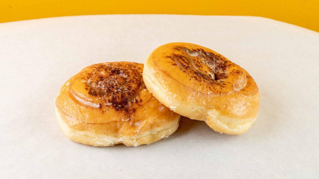 Cinnamon Roll · Swirly, glazed donut with sprinkles of cinnamon powder.