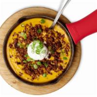 Jack'S Skillet Queso · Loaded with Seasoned Ground Beef, Sour Cream and Green Onions. Served with Tortilla Chips an...