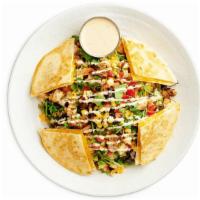 Southwest Quesadilla Chicken Salad · Grilled Chicken, Black Bean Corn Relish, tomatoes, mixed cheese, cilantro drizzled with Chip...