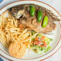 Mojarra Frita · Swwet water (tilapia) fried and served with rice, fries and salad. Servida con arroz, papas ...