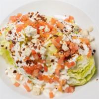 Wedge Salad · 1/4 wedge of iceberg lettuce topped with bleu cheese, diced tomatoes, and bacon bits. Add ch...