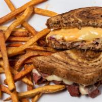 Jj'S Reuben · Boar's Head corned beef with sauerkraut, 1000 Island dressing and melted Swiss cheese on mar...