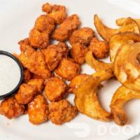 Lt'S Chicken Bites · Large pile of chicken bites served with golden brown fries and ranch. Toss in your favorite ...