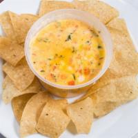Queso · Classic House Velvety Queso, Crispy Chips.