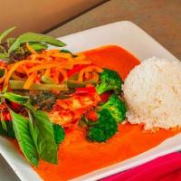 Salmon Red Curry · Grilled salmon sushi grade served with steamed vegetables, red curry sauce and steamed rice.