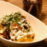 Frito Pie · A heaping pile of super scoop Fritos covered in choice of chilli, cheddar cheese, Onions, to...