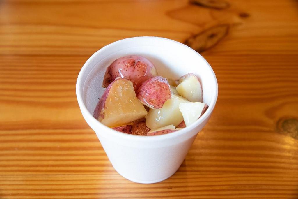 Buttered New Potatoes · Red potatoes boiled in salt water and served with melted butter.
