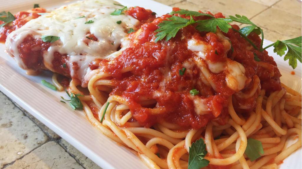 Chicken Parmigiana · Lightly breaded chicken breast topped with marinara and mozzarella served with a side of spaghetti marinara.