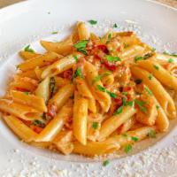 Penne Alla Luciano'S · Penne pasta with chicken, bacon, garlic, and basil served in pink sauce.
