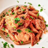 Penne Rustiche · Shrimp in creamy pink sauce, sun-dried tomatoes, mushrooms, garlic, and basil.