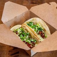 Double Taco · Made with our coco shrimp! Fresh romaine, sweet chili sauce and our home made cilantro-lime ...
