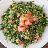Tabbouleh Salad · Chopped parsley mixed with diced Tomatoes, bulgur wheat and topped With olive oil and lemon ...