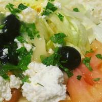 Greek Salad · Freshly Chopped Romaine and iceberg lettuce, Tomatoes, Cucumbers, topped with feta cheese an...