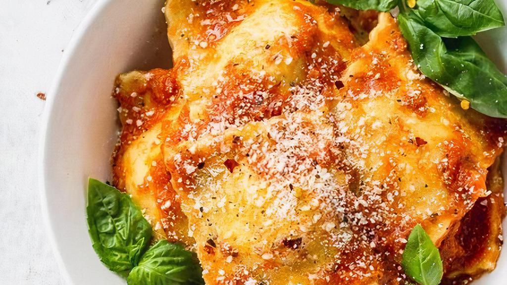 Cheese Ravioli · Ravioli topped with tomato sauce and melted mozzarella cheese