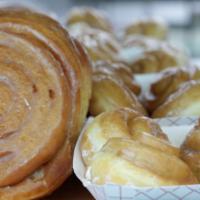 Cinnamon Rolls · Large pastry roll filled with cinnamon and covered in glaze.