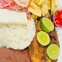 Fried Whole Tilapia (Pescado Frito) · Served with rice, refried beans, cheese, cabbage salad, pico de gallo, choice of fried banan...