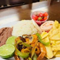Grilled Shrimp (Camarones A La Plancha) · Served with rice, refried beans, cheese, cabbage salad, choice of fried banana slices or tor...
